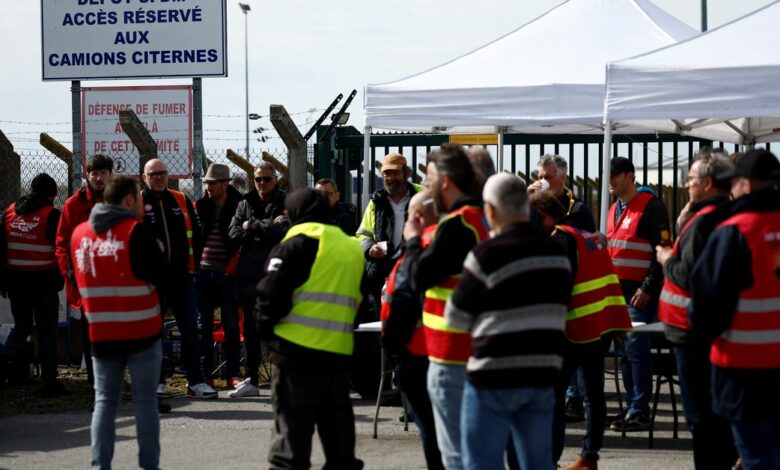 Workers on strike gather in front of the oil depot of the SFDM company in Donges