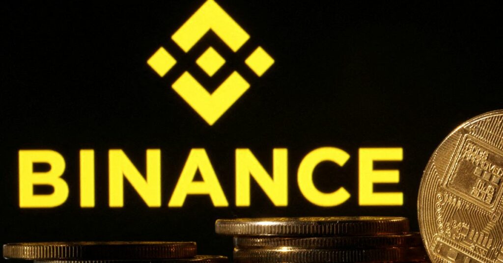 Illustration shows Binance logo and representation of cryptocurrencies