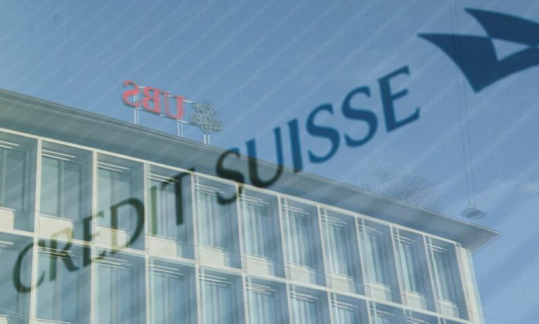 Logos of Swiss banks UBS and Credit Suisse are seen in Zurich