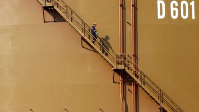 A worker walks down the stairs of an oil tank at Turkey