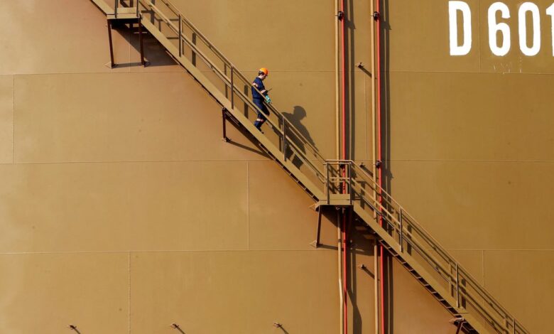 A worker walks down the stairs of an oil tank at Turkey