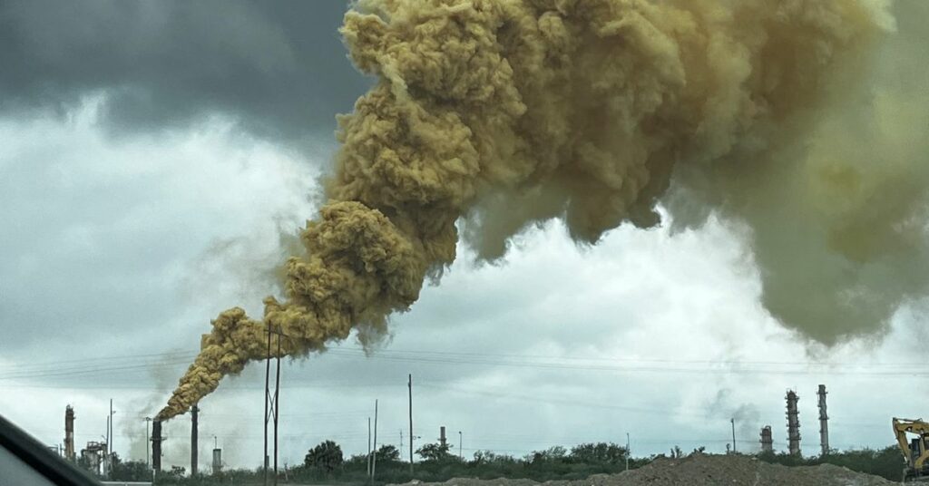 A smokestack emits yellow smoke in Cadereyta Jimenez