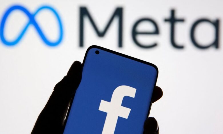A smartphone with Facebook's logo is seen in front of displayed Facebook's new rebrand logo Meta in this illustration