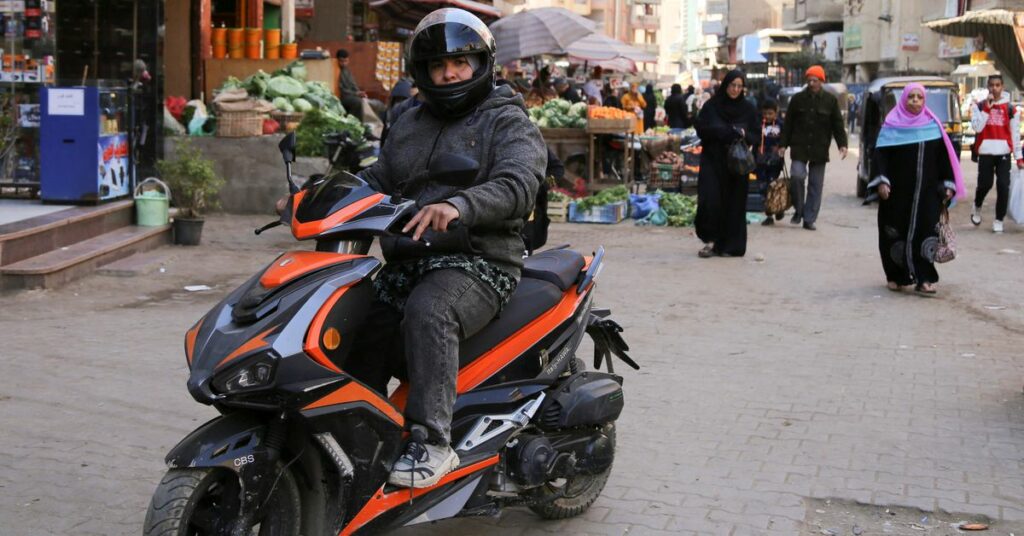 Egyptian scooter courier Eman Al-Adawi provides taxi service for women