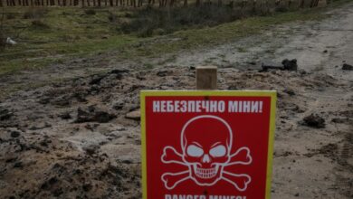 A mine danger sign and anti-tank constructions are seen near the border with Belarus in Volyn region