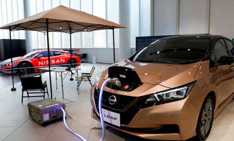 A Nissan Leaf EV car and portable battery on display at Nissan Gallery in Yokohama