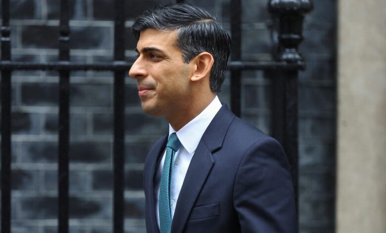 British PM Sunak walks outside Number 10 Downing Street, in London