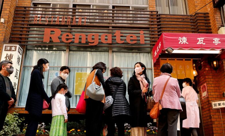 People form a line as they try to have lunch at Rengatei restaurant in Tokyo