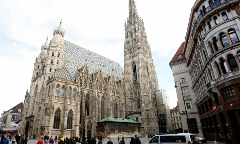 An Austrian police car passes St. Stephens cathedral in Vienna