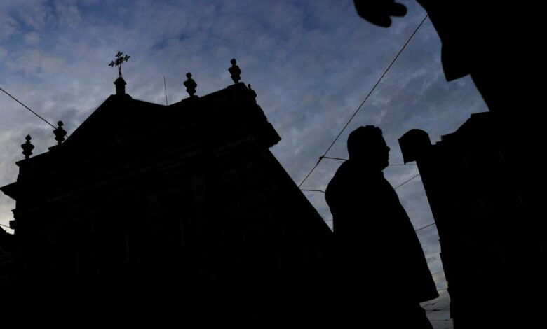 People walk by a church on the day Portugal's commission investigating allegations of historical child sexual abuse by members of the Portuguese Catholic church will unveil its report, in Lisbon