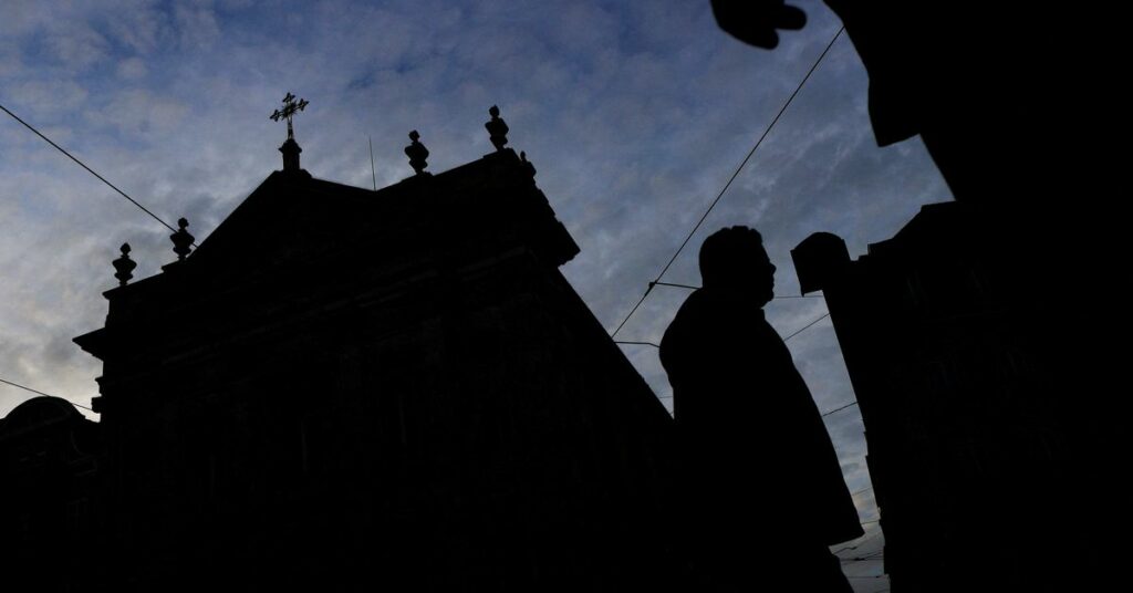 People walk by a church on the day Portugal's commission investigating allegations of historical child sexual abuse by members of the Portuguese Catholic church will unveil its report, in Lisbon