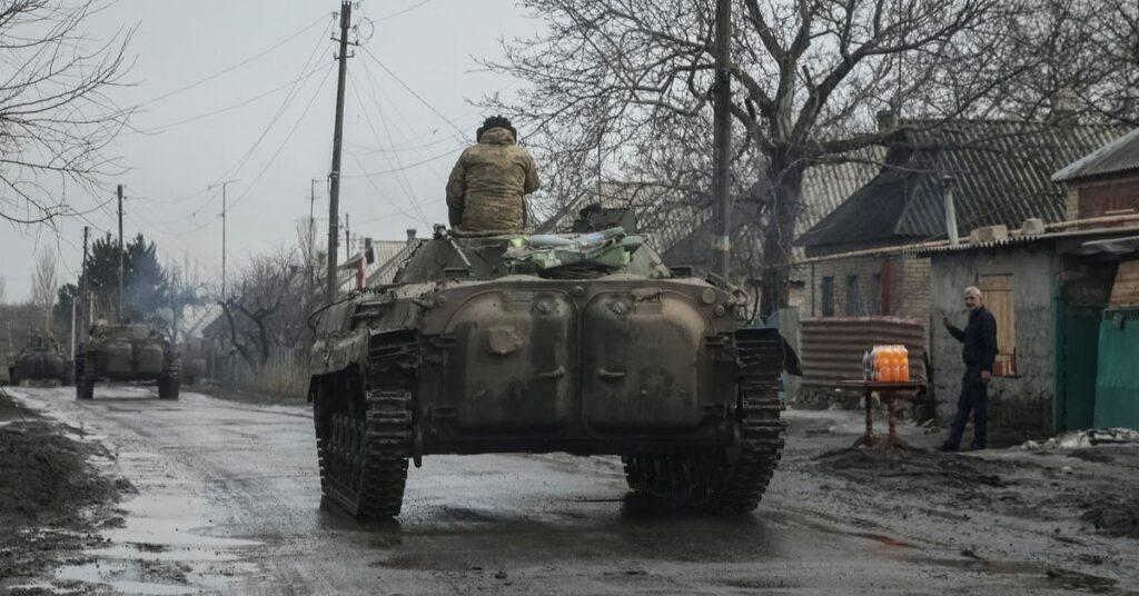 Ukrainian service members ride BMP-2 infantry fighting vehicles near Bakhmut
