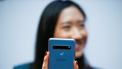 A Samsung employee poses with the new Samsung Galaxy S10 5G smartphone at a press event in London