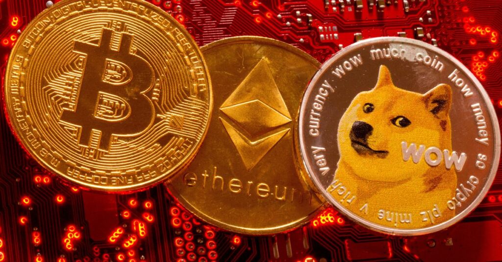 Representations of cryptocurrencies Bitcoin, Ethereum and DogeCoin are placed on PC motherboard in this illustration taken