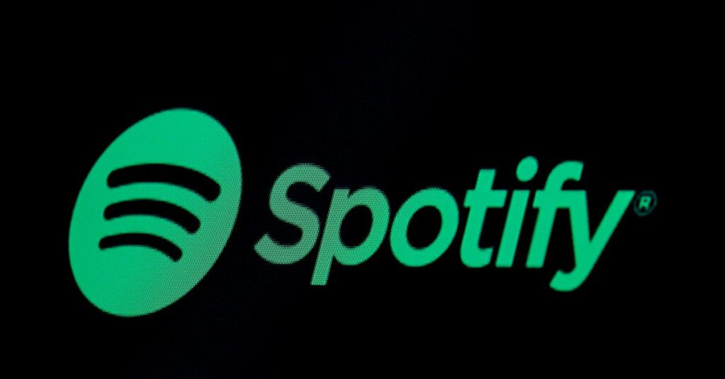 The Spotify logo is displayed on a screen on the floor of the NYSE in New York