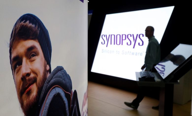 A man walks through the Synopsys booth during the Black Hat information security conference in Las Vegas