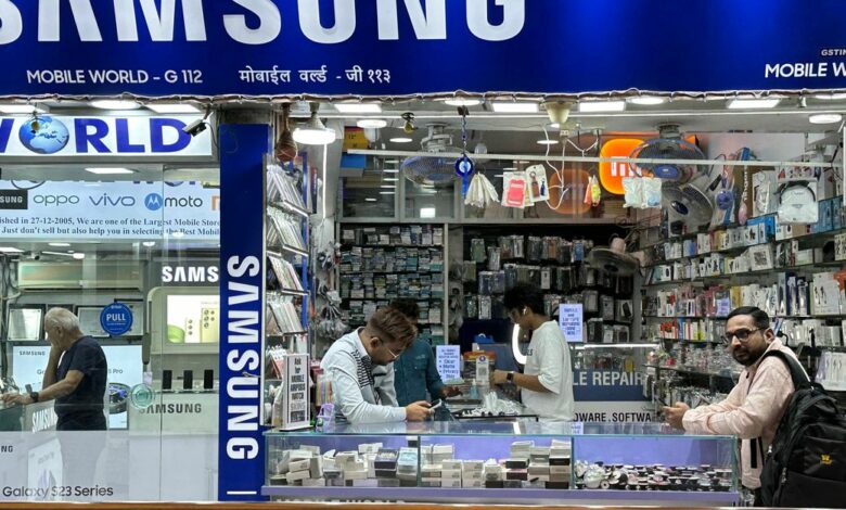 People shop inside a store selling Samsung mobile phones and accessories in Mumbai
