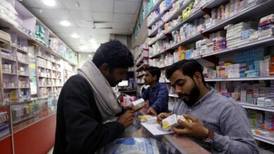 A customer buys medicine from a medical supply store in Karachi