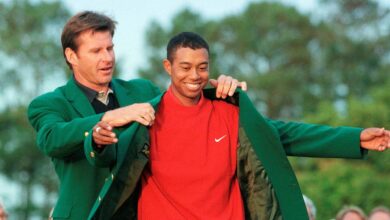 Tiger Woods of the U.S. is given the victor's green jacket after winning the Masters golf tournament in Augusta