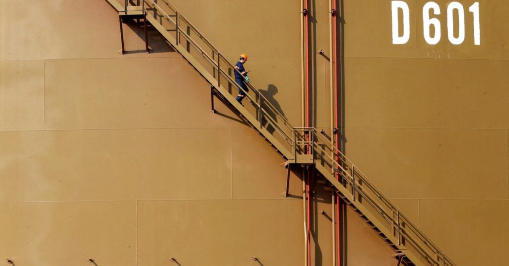 A worker walks down the stairs of an oil tank at Turkey's Mediterranean port of Ceyhan