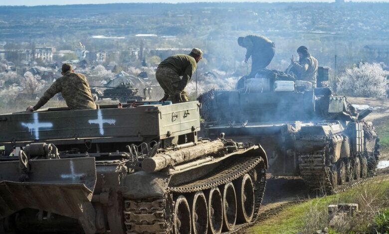 Ukrainian service members ride tanks near the front line city of Chasiv Yar