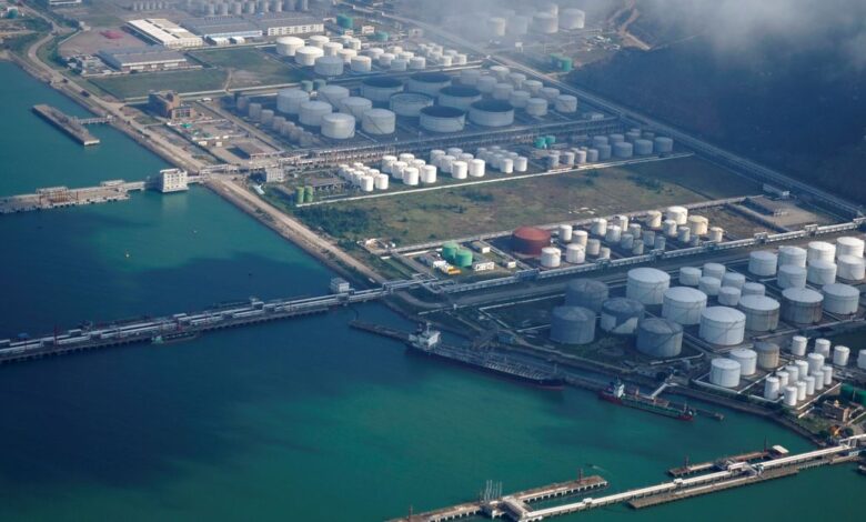 Oil and gas tanks are seen at an oil warehouse at a port in Zhuhai