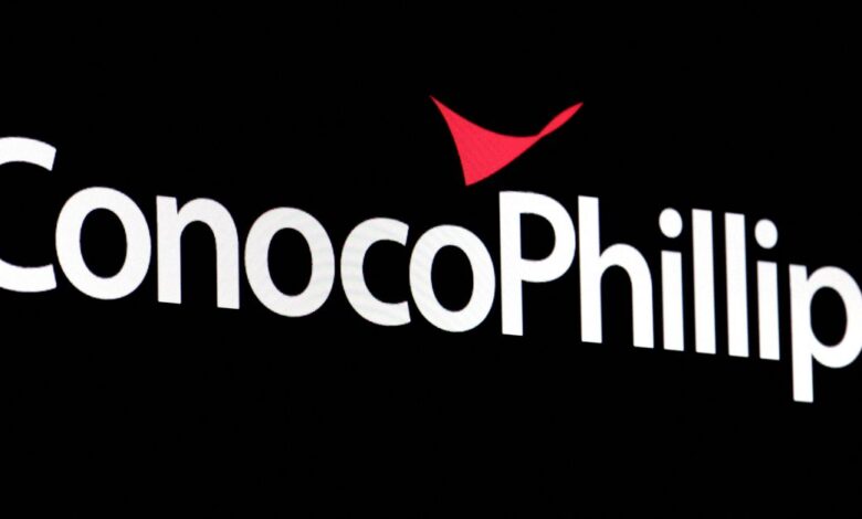 A screen displays the logo for ConocoPhillips on the floor of the NYSE in New York