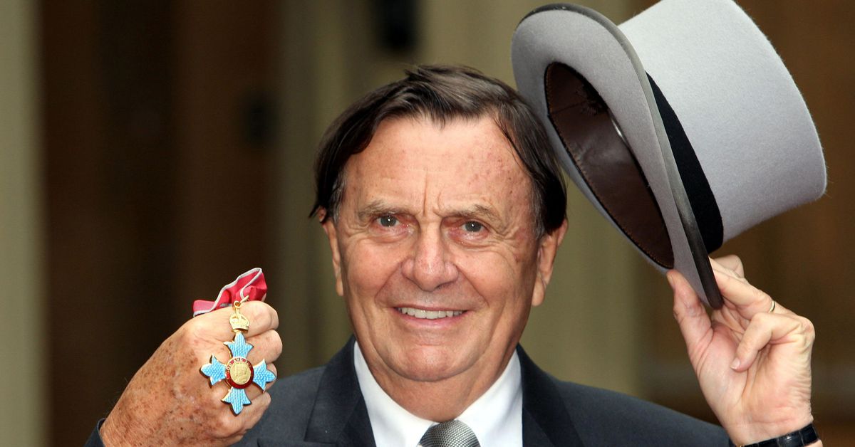 Australia's Barry Humphries poses after receiving his Most Excellent Order of the British Empire from the Queen at Buckingham Palace, London
