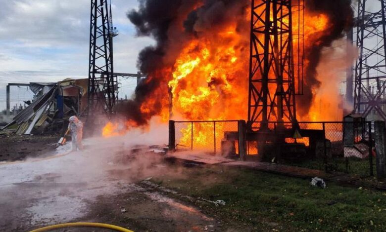 Firefighters work to put out a fire at energy infrastructure facilities, damaged by a Russian missile strike