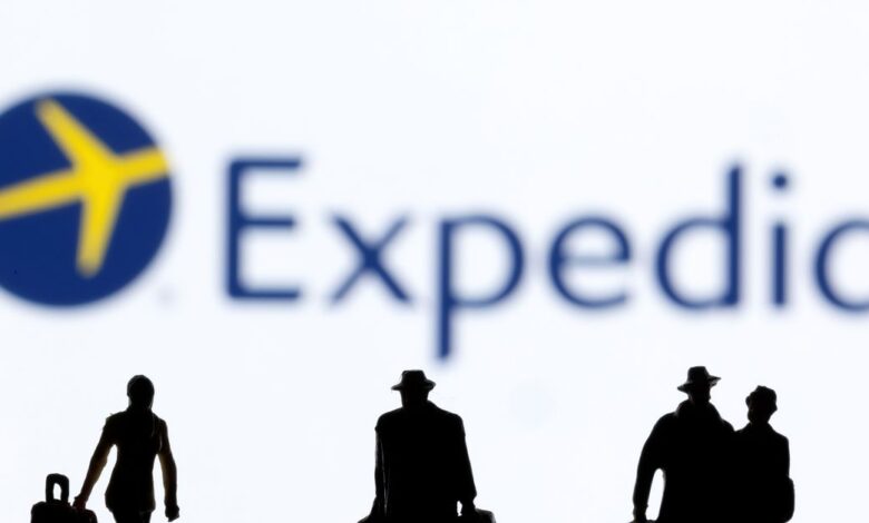 Figurines are seen in front of Expedia logo