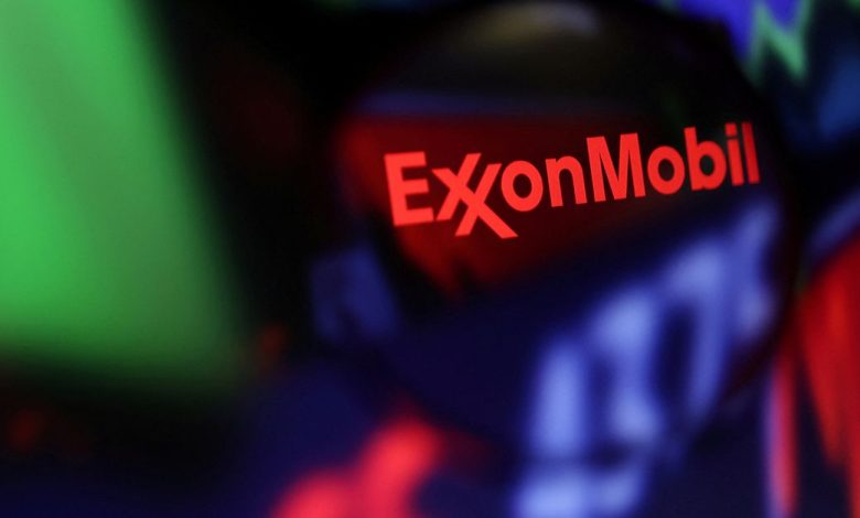 Illustration shows Exxon Mobil logo and stock graph