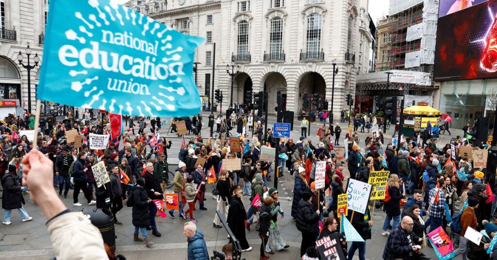 Teachers attend a march during strike action in a dispute over pay, in London