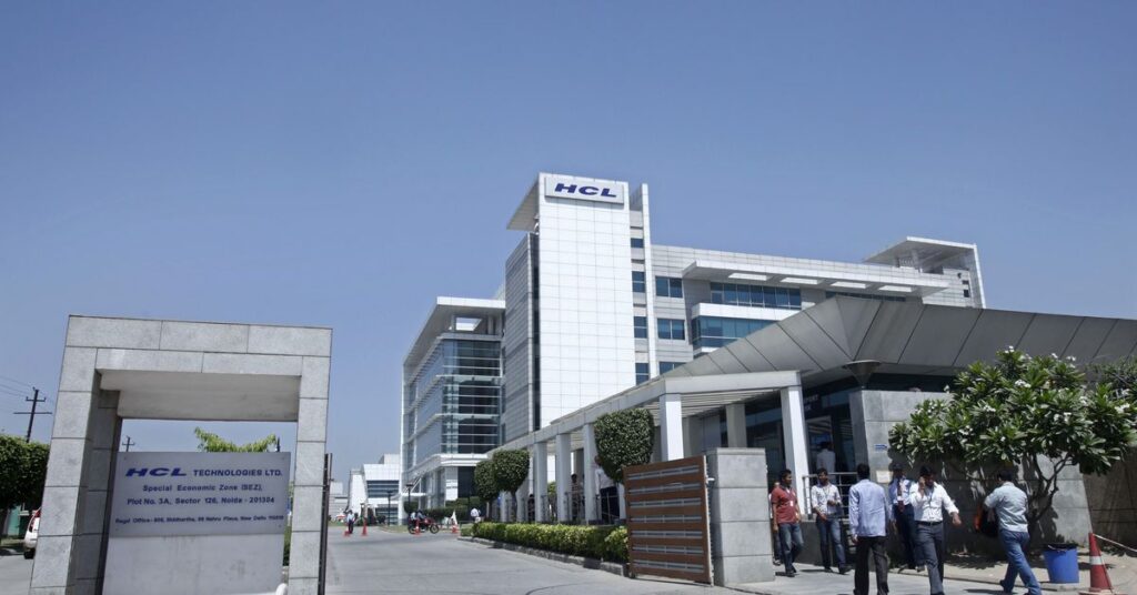 People walk in front of the HCL Technologies Ltd office at Noida