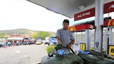 A man fills tanks with gas in Cucuta