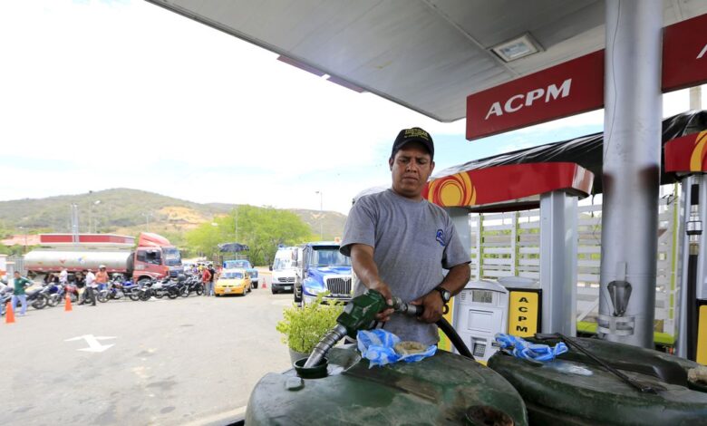 A man fills tanks with gas in Cucuta