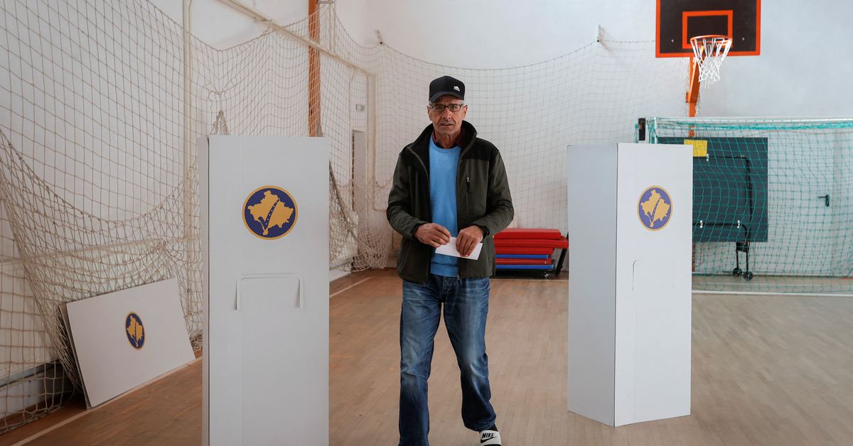 A Kosovo Albanian man prepares to vote at a polling station in the village of Qabra