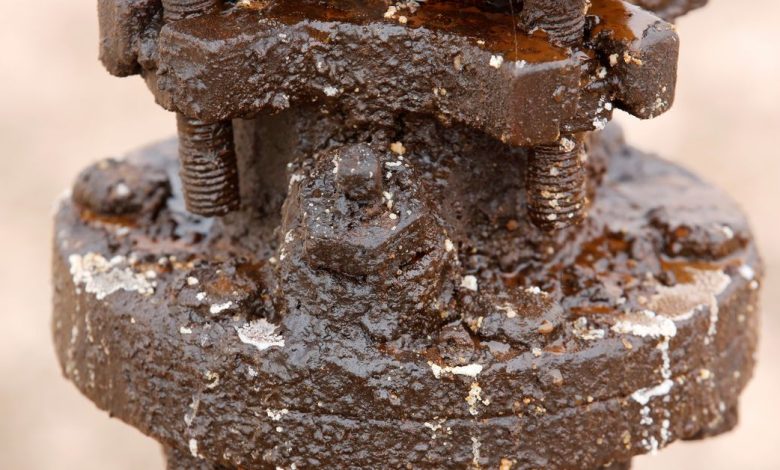 Crude oil and grease is seen caked on a pump jack in the Permian Basin in Loving County