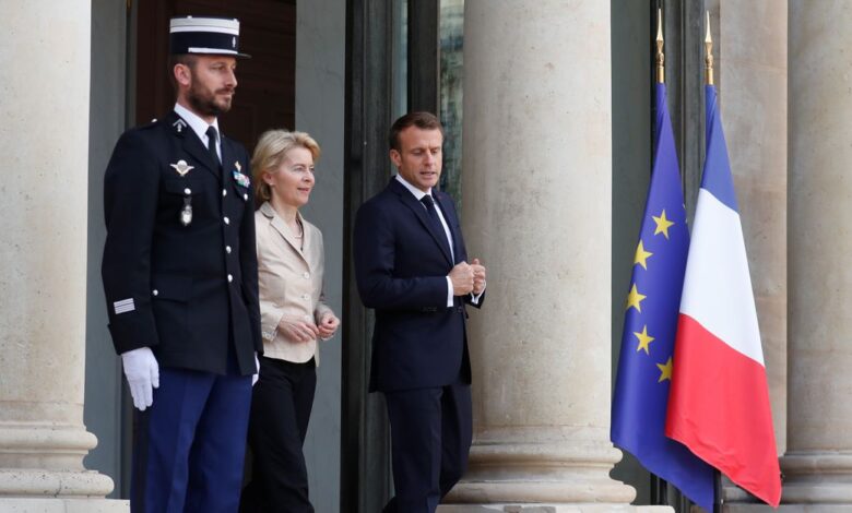 French President Emmanuel Macron talks with European Commission president-elect Ursula Von der Leyen as she leaves at the Elysee Palace in Paris