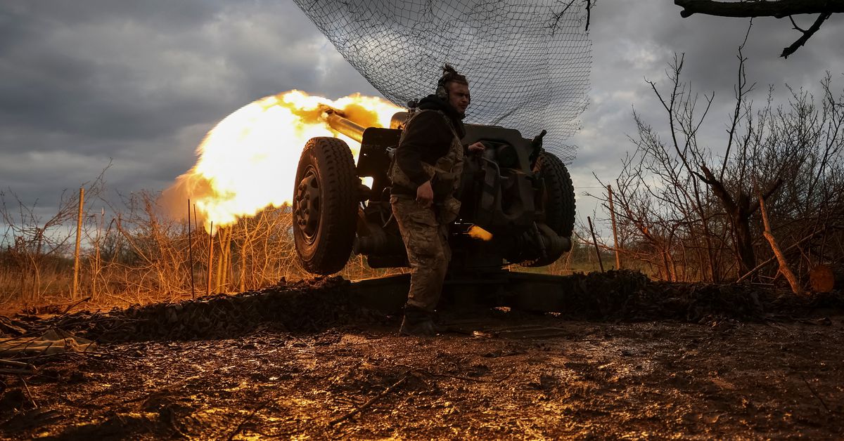Ukrainian service members fire a howitzer D30 at a front line near the city of Bakhmut