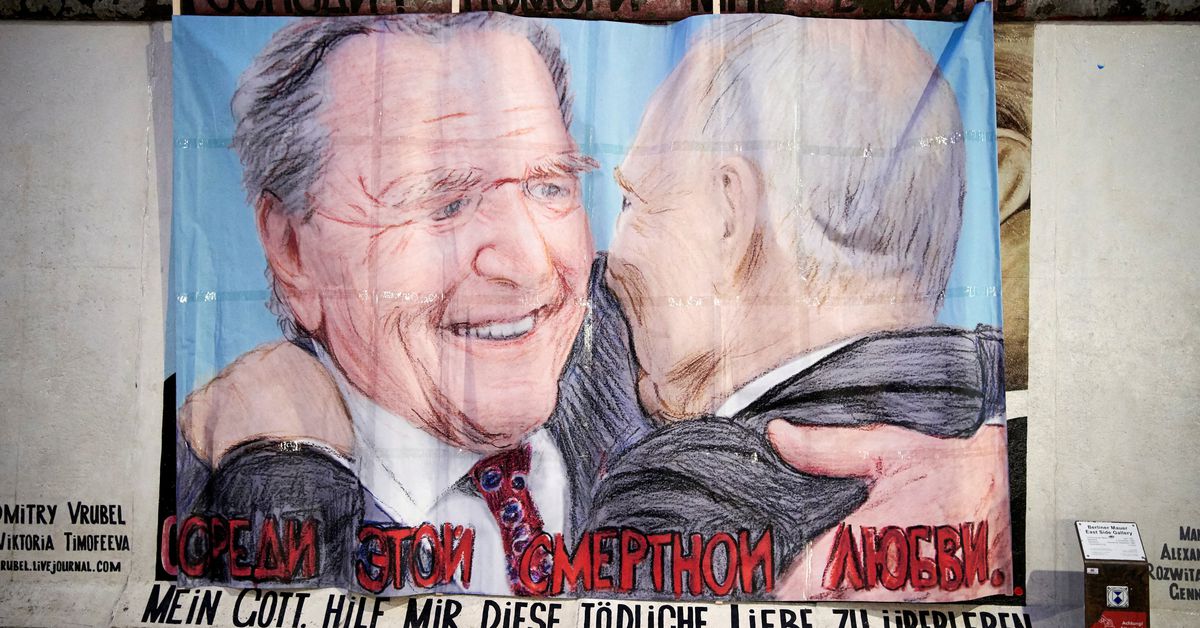 Former German Chancellor Schroeder and Russian President Putin are depicted in this graffiti exchanging a kiss at Berlin's East Side Gallery