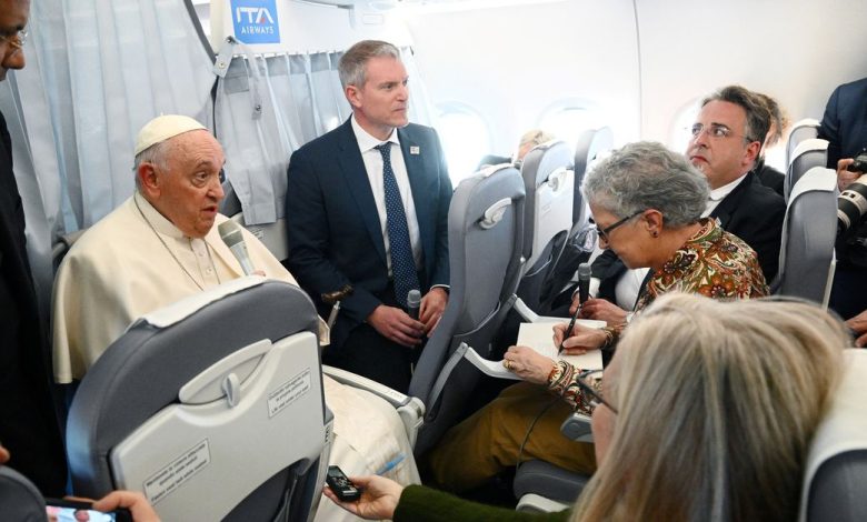 Pope Francis holds a news conference aboard the plane as he returns to the Vatican following his apostolic journey to Hungary
