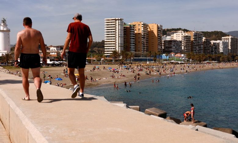 People enjoy the weather on a beach in Malaga