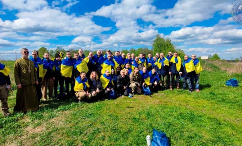 Ukrainian prisoners of war (POWs) pose for a picture after a swap at an unknown location in Ukraine