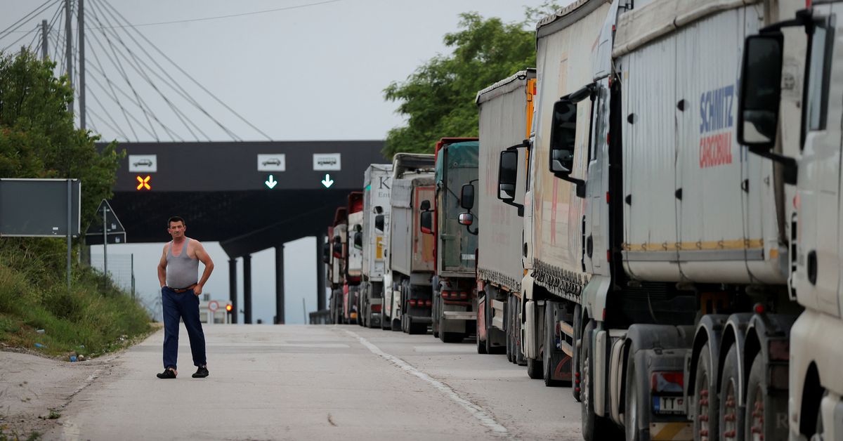 Trucks with goods queue at the Kosovo-Serbia border crossing in Merdare
