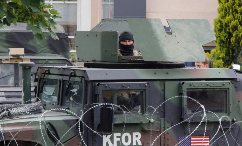 Members of the NATO-led Kosovo Force (KFOR) stand guard in Leposavic